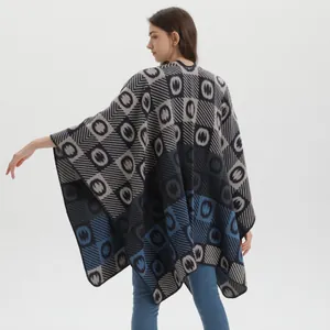 Detail of soft knit shawl with gray and blue geometric textured patterns for women