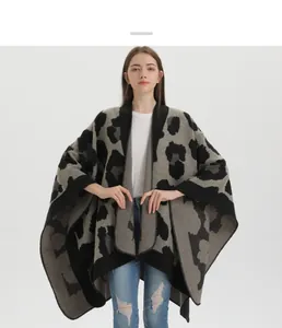 Detail of grey leopard knit shawl poncho featuring premium hemmed edges and draped fit