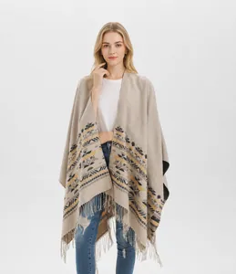 Detail of bohemian knitted shawl with geometric stripe patterns and long fringe edges