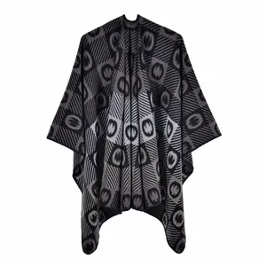 Close-up detail of the thick jacquard knitting and geometric pattern on a gray poncho