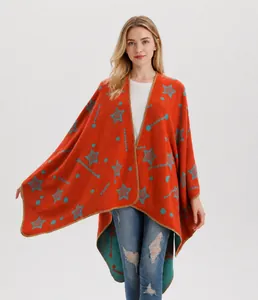 Detail of soft knit shawl with orange and blue contrast, featuring star patterns and stitching