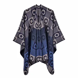 Close-up of knit shawl texture with navy geometric jacquard pattern and split design