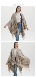 Detail view of khaki bohemian knit poncho with geometric patterns and tassel hem fringe