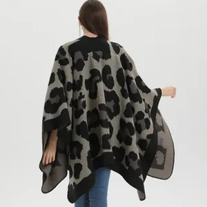 Back view of elegant leopard print knit poncho cape for women in grey and black
