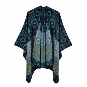 Detail of knitted poncho shawl with bohemian geometric patterns in navy and mustard yellow