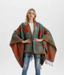 Close-up of winter knit shawl with orange plaid pattern and long black fringe details
