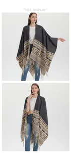 Close-up of bohemian knit shawl with geometric patterns and long tassel fringe details