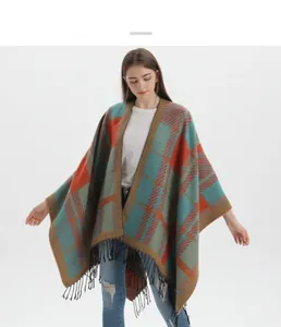 Detail view of colorful checkered knit shawl showing long black fringe and soft texture