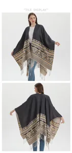 Detail of bohemian knit shawl with geometric patterns and fringe hem on model