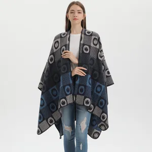 Fashionable geometric knit shawl poncho with ethnic patterns and warm fringe details