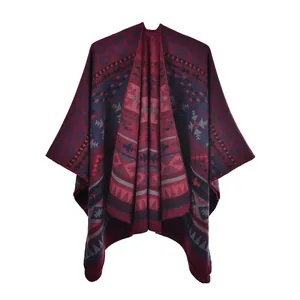 Detail of red and blue bohemian knit poncho with geometric tribal patterns and slit design