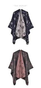 Flat lay of knit ponchos with star patterns in navy-cream and grey-purple colorways