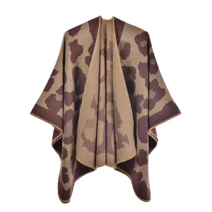 Detail of leopard print knitted poncho featuring thick cashmere-like texture and stitching