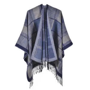 Close-up of blue and grey plaid knit shawl featuring delicate tassel trim details