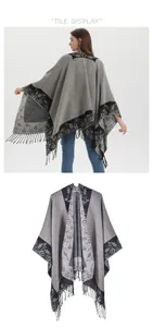 Detail of grey knitted poncho with vintage floral patterns and fringe tassels