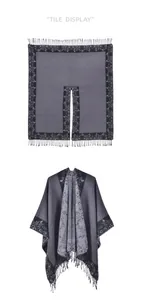 Detail view of grey and black split shawl with floral patterns and tassel trim