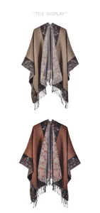 Detail of knitted poncho shawls with jacquard borders and black tassels in two colors