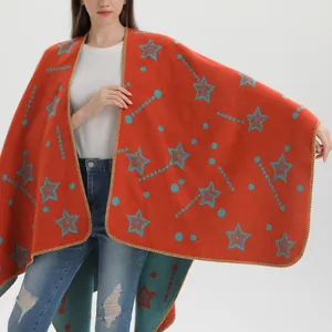 Knitted split shawl cape with vibrant orange base and blue star polka dot patterns