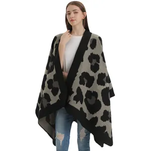 Women's leopard print shawl knit poncho with wide black border and oversized fit