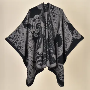 Close-up of ethnic paisley pattern on a soft black and grey knitted winter shawl