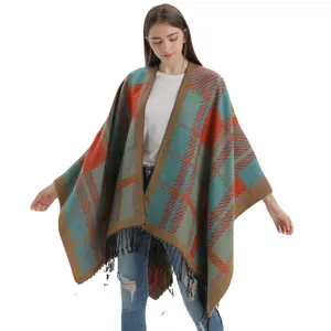 Women's plaid tassel poncho with split front in rust red, green, and khaki knit