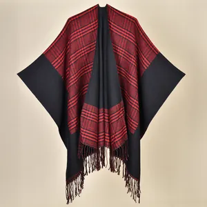Close-up of ethnic style knit shawl with red and black stripes and dense fringe tassels