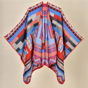 Detail of bohemian knit shawl with colorful geometric patterns and red stitched edges