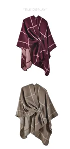 Detail display of wine red and khaki plaid shawl cape with textured knit and waist tie