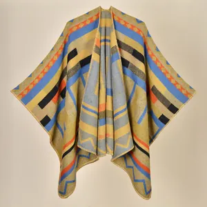 Detailed view of the woven geometric knit texture and colorful tribal patterns on the poncho
