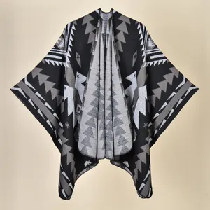 Detailed view of knitting texture and geometric patterns on this ethnic style black poncho