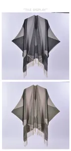 Detail of soft knit shawl wrap featuring geometric patterns and long fringe tassels