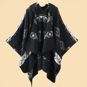 Close-up of the knitted texture and geometric ethnic patterns on the hooded poncho