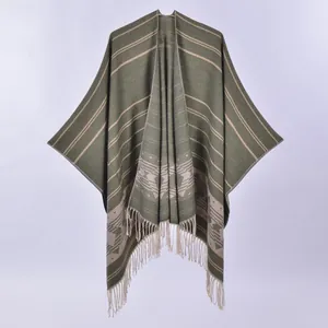 Detail of vintage dark green knitted shawl with geometric patterns and fringe hem