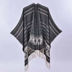 Bohemian knitted poncho with geometric patterns and fringe tassels in grey and white