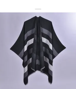 Detail of soft knit shawl featuring multi-color stripes and delicate fringe edges