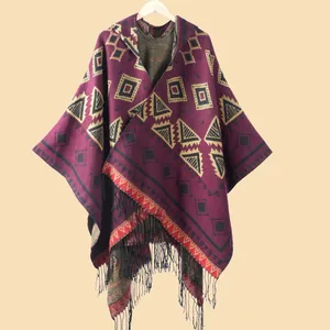 Bohemian striped knit shawl cape with geometric patterns and black fringe tassels
