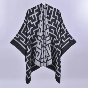 Black and grey geometric knit poncho cape with reversible minimalist maze pattern