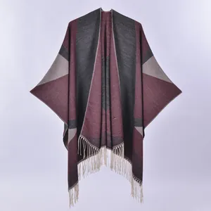 Bohemian geometric knit poncho with long tassels in burgundy and charcoal grey