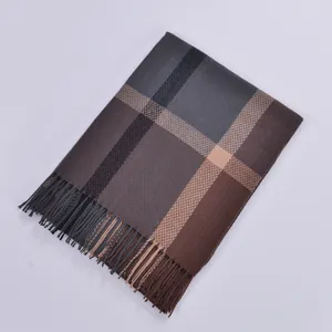 Close-up of classic brown and grey plaid cashmere scarf with soft tassel fringe detail