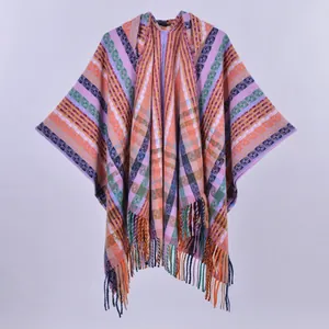 Ethnic bohemian hooded knit poncho with colorful geometric stripes and tassel fringe