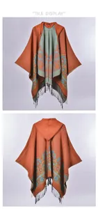 Flat display of hooded knit poncho showing orange floral patterns and tassel details