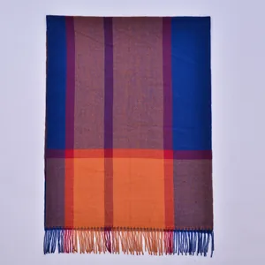 Detailed view of long plaid cashmere scarf with orange and blue fringe texture