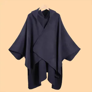 Detailed knit texture and seamless edge stitching on a navy hooded poncho cape
