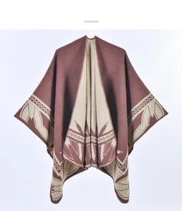 Detailed view of the bohemian knit poncho with ethnic patterns and beige geometric edges