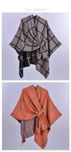 Detail showing the gray and orange plaid pattern and tie-front knot on this shawl