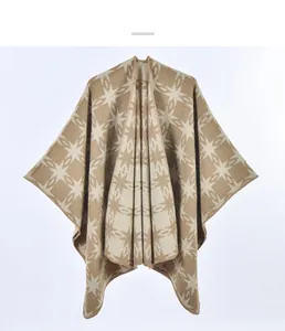Detail of khaki star pattern knitted shawl with fine stitching on the open front edges