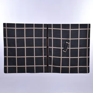 Detail of dark grey plaid shawl with beige check pattern and adjustable strap tie