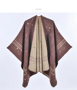 Detail of double-sided knit shawl showing geometric patterns and fringe edges