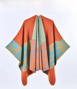 Detailed view of geometric pattern knit poncho with colorful jacquard and overlock edges