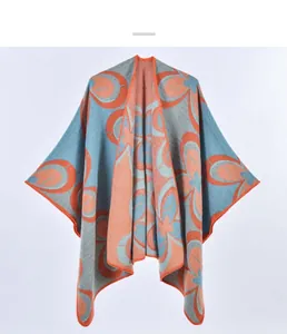 Detailed knit texture of vintage orange and grey-blue floral shawl cape with lockstitching